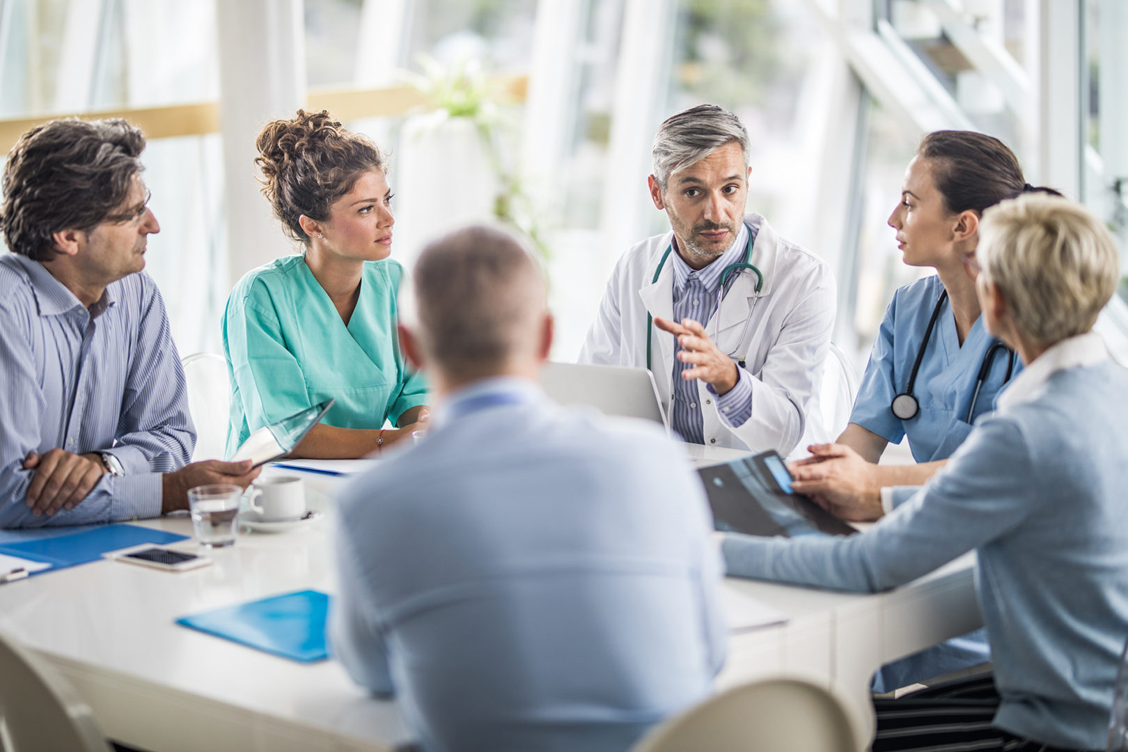 team-of-doctors-and-business-people-talking-on-a-meeting-at-doctors-office